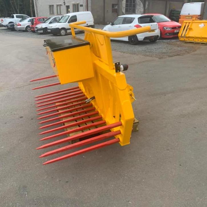 Hydraulic tipping stone fork with tool/weight box